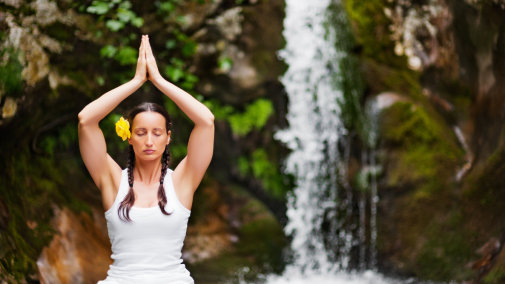 Immersing in Nature's Embrace with a lady in yoga pose beside the waterfall. Intuitive Nature